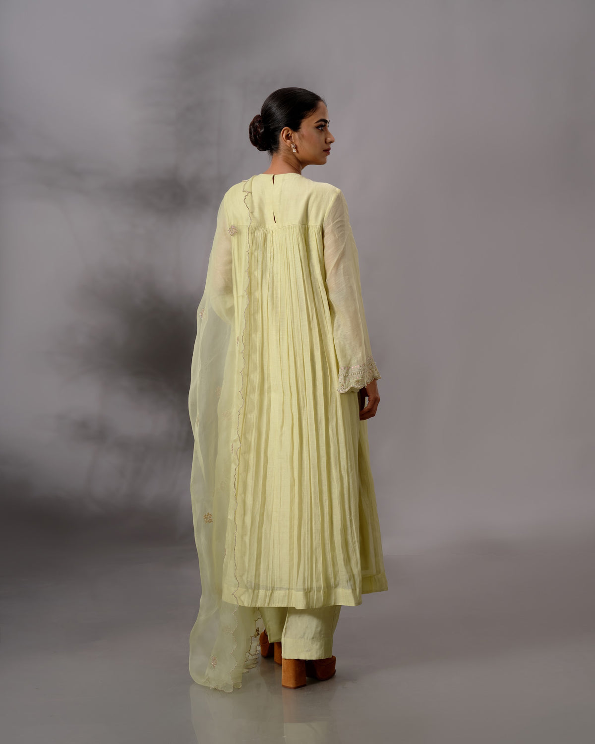Model wearing the Pale Lime Yellow Gathered Salwar Set by Kpret by Kalakaari